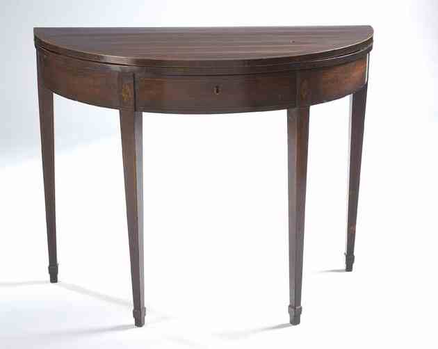 A late George III period mahogany and crossbanded demi-lune foldover table