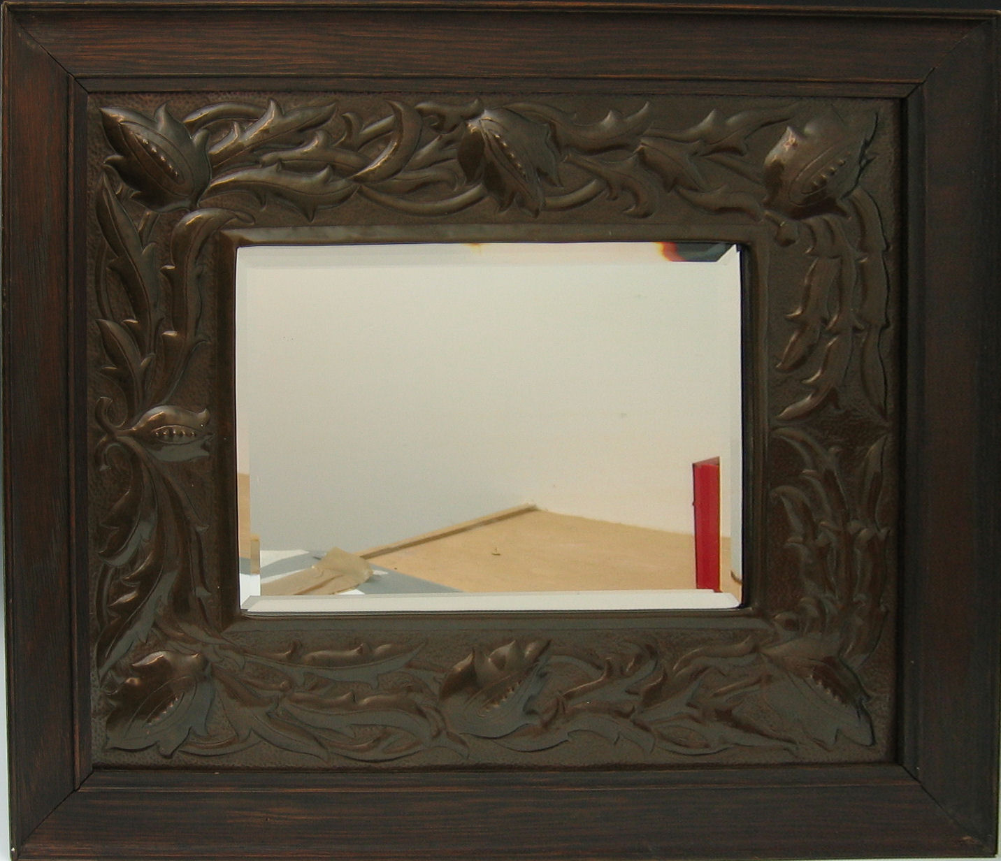 A Keswick style mirror oak and copper-framed mirror