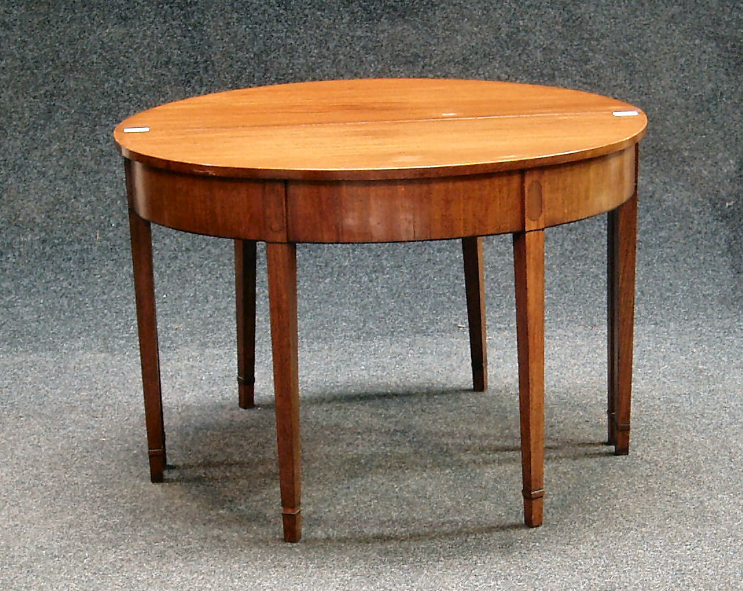 A George III mahogany and ebony strung D-end dining table,