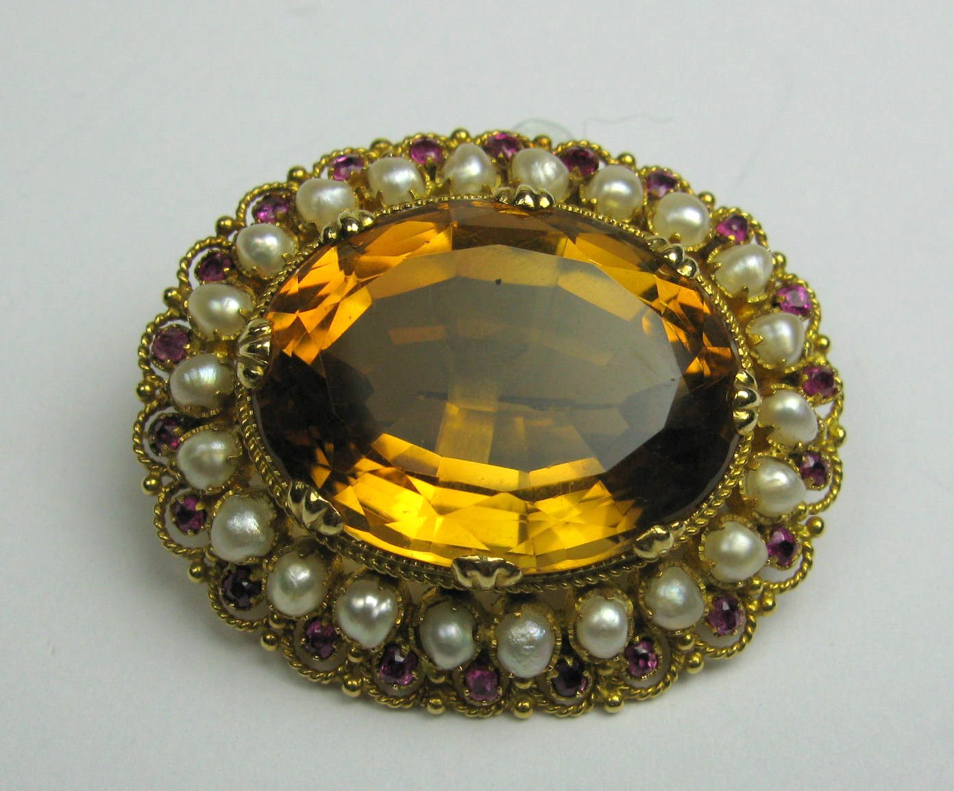A Victorian gold mounted shaped oval brooch