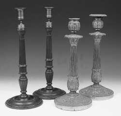 A pair of mahogany candlesticks of George III design