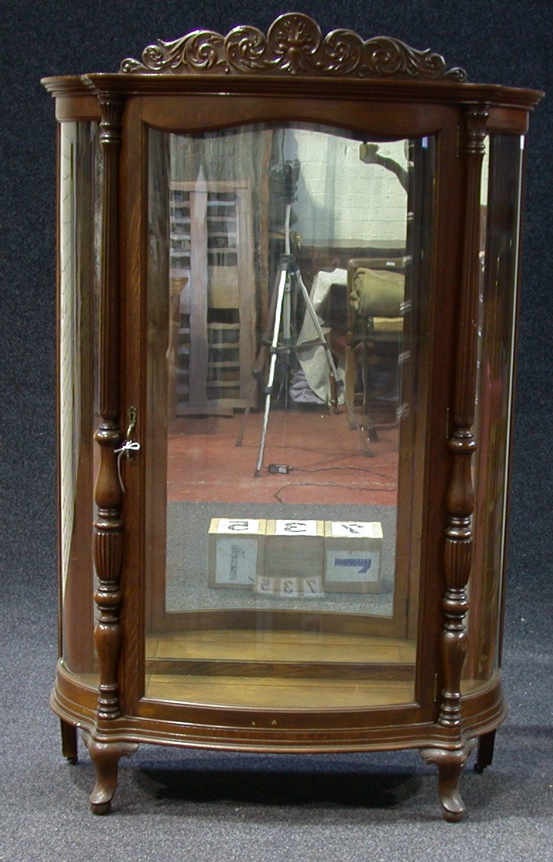 A late Victorian oak demi-lune vitrine,