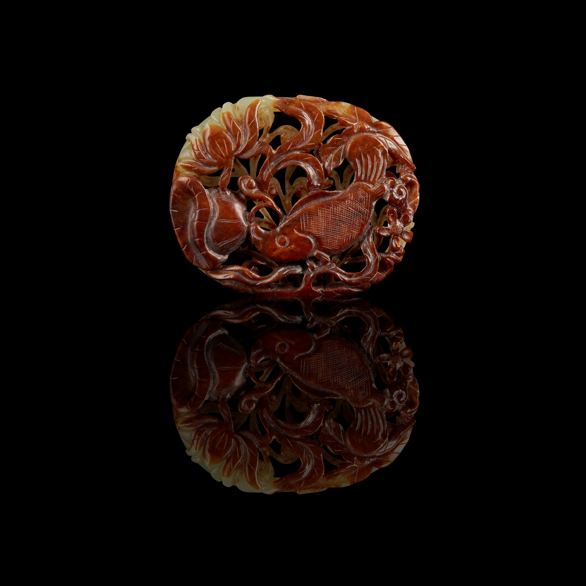 CELADON JADE WITH RUSSET-SKIN 'FISH AND LOTUS POND' OVAL BELT PLAQUE