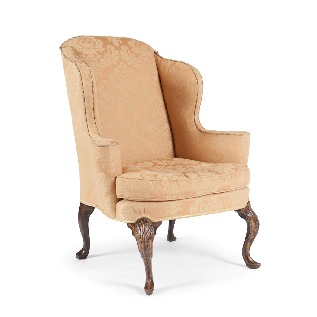 A QUEEN ANNE WALNUT FRAMED AND UPHOLSTERED WING ARMCHAIR