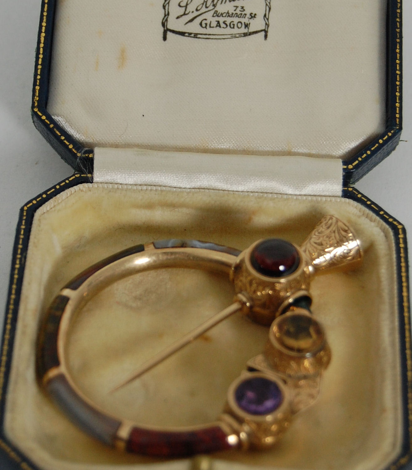 A Victorian Scottish market gold hardstone penannular brooch