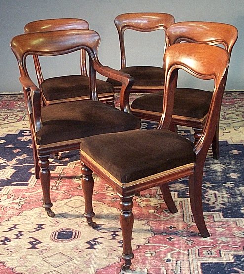 A set of five yoke back dining chairs