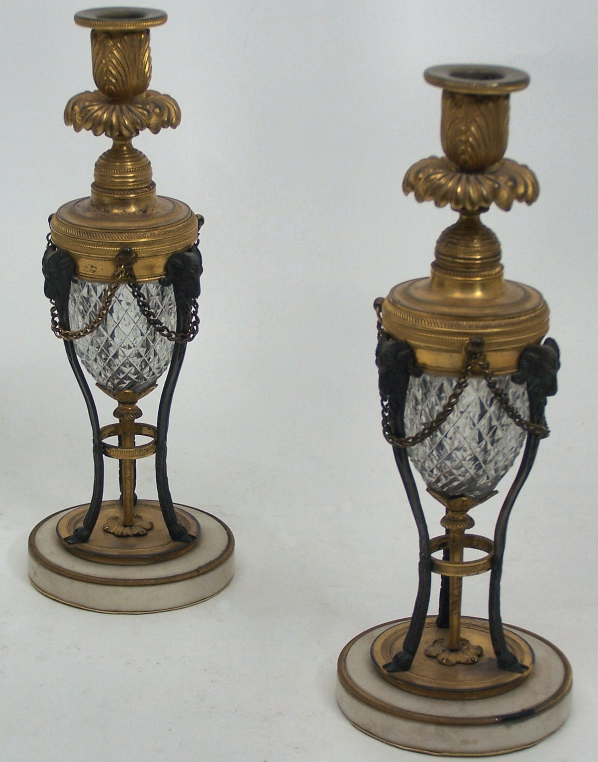 A pair of early 19th century giltbronze, bronze and cut glass candlesticks, circa 1810