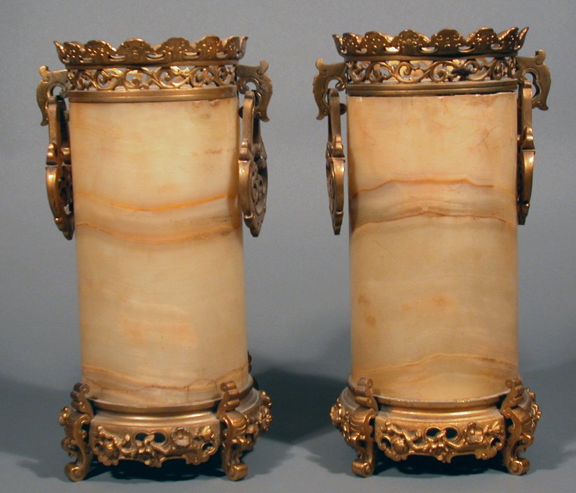 A pair of gilt bronze mounted cylindrical alabaster vases