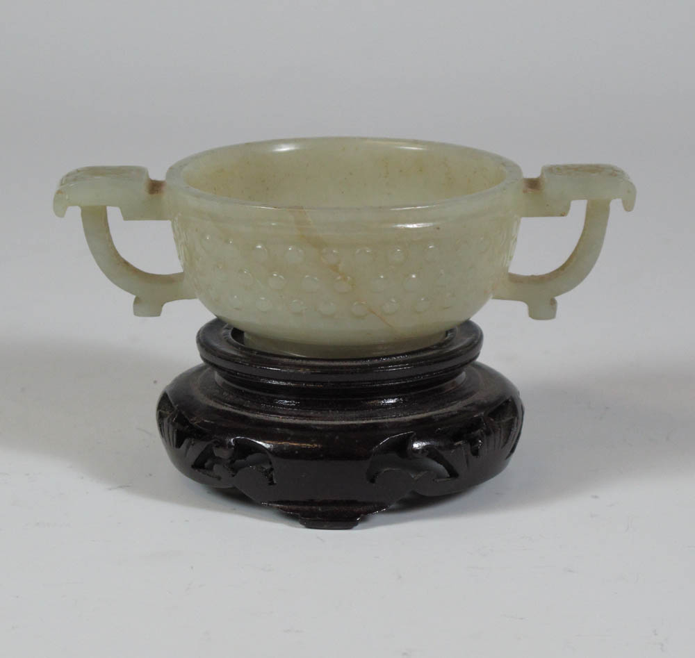 A Chinese pale green jade cup