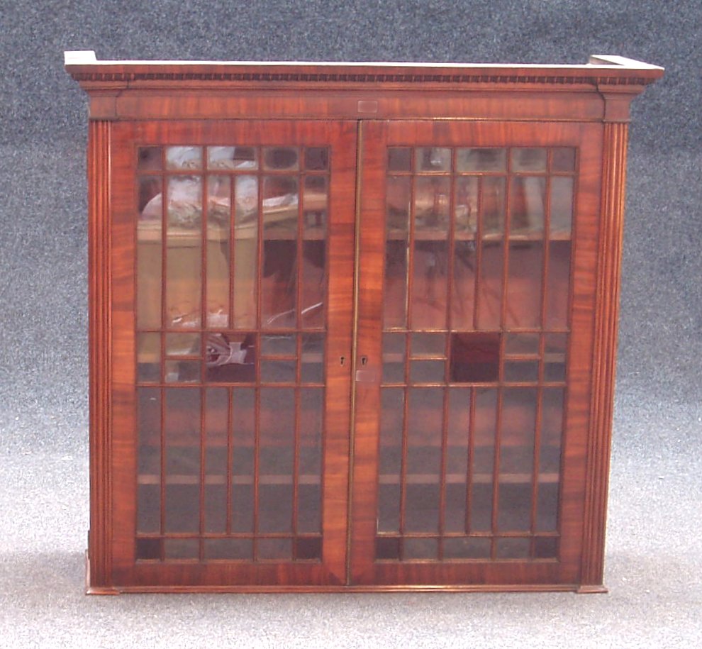 A Regency mahogany bookcase top,