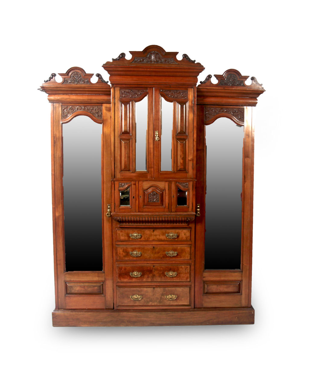 A late Victorian mahogany carved breakfront wardrobe