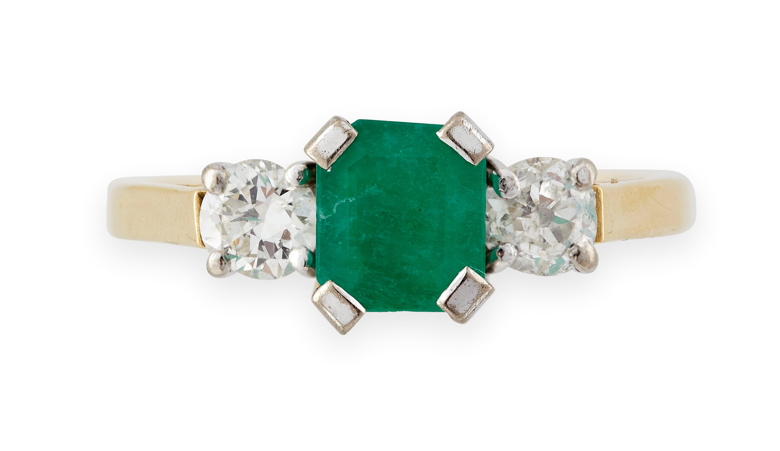 An 18ct gold mounted emerald and diamond three-stone ring