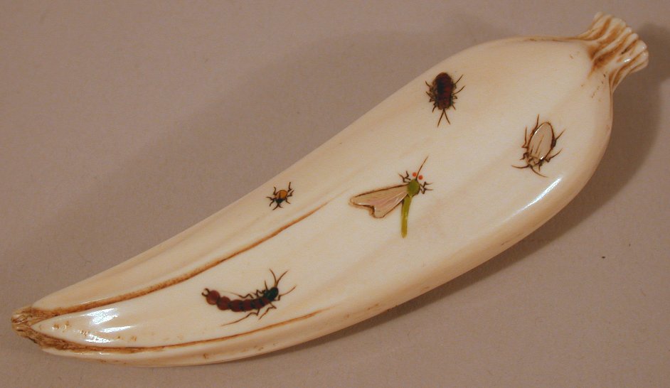 A Japanese carved ivory shibyama decorated long bean