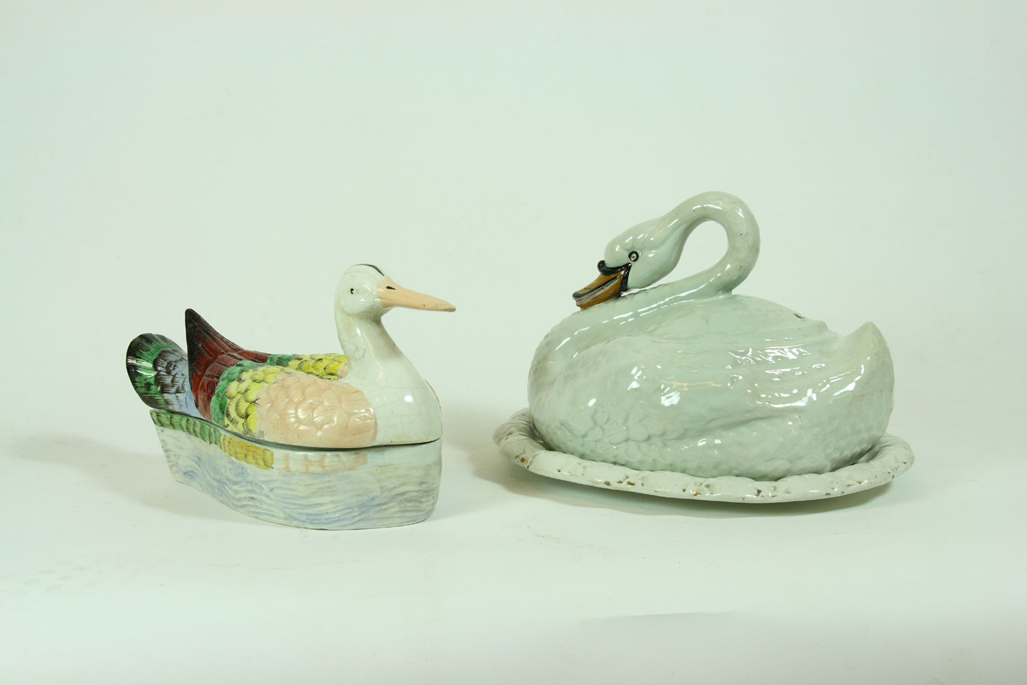 A mid 19th century polychrome ceramic duck shaped tureen and base
