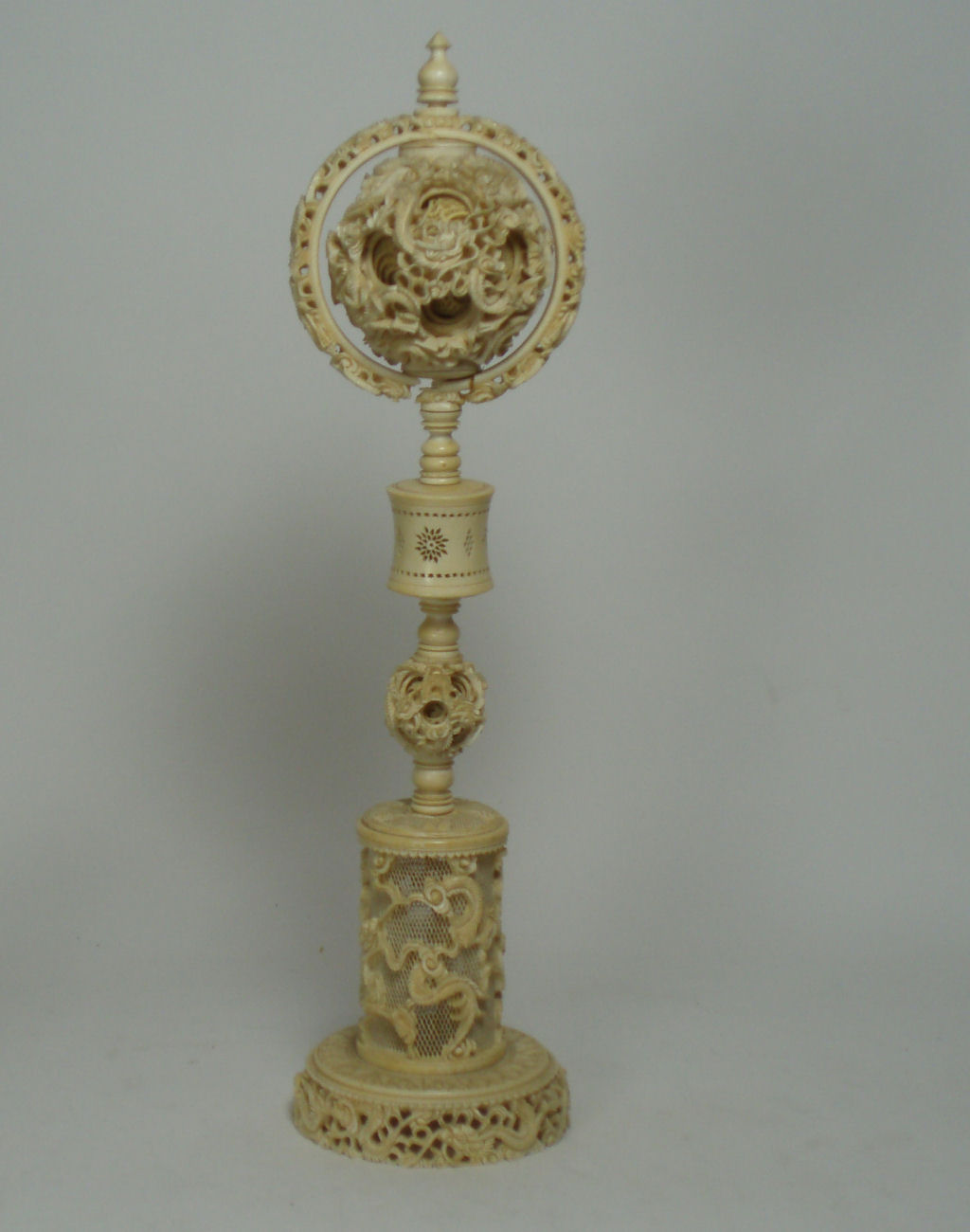An early 20th century Chinese ivory puzzle ball on stand