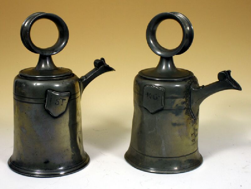 Two unusual 19th century pewter bell shaped containers with spouts