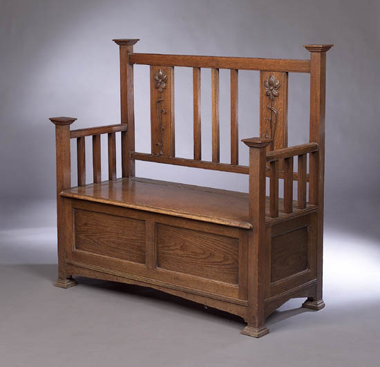An Arts and Crafts oak settle