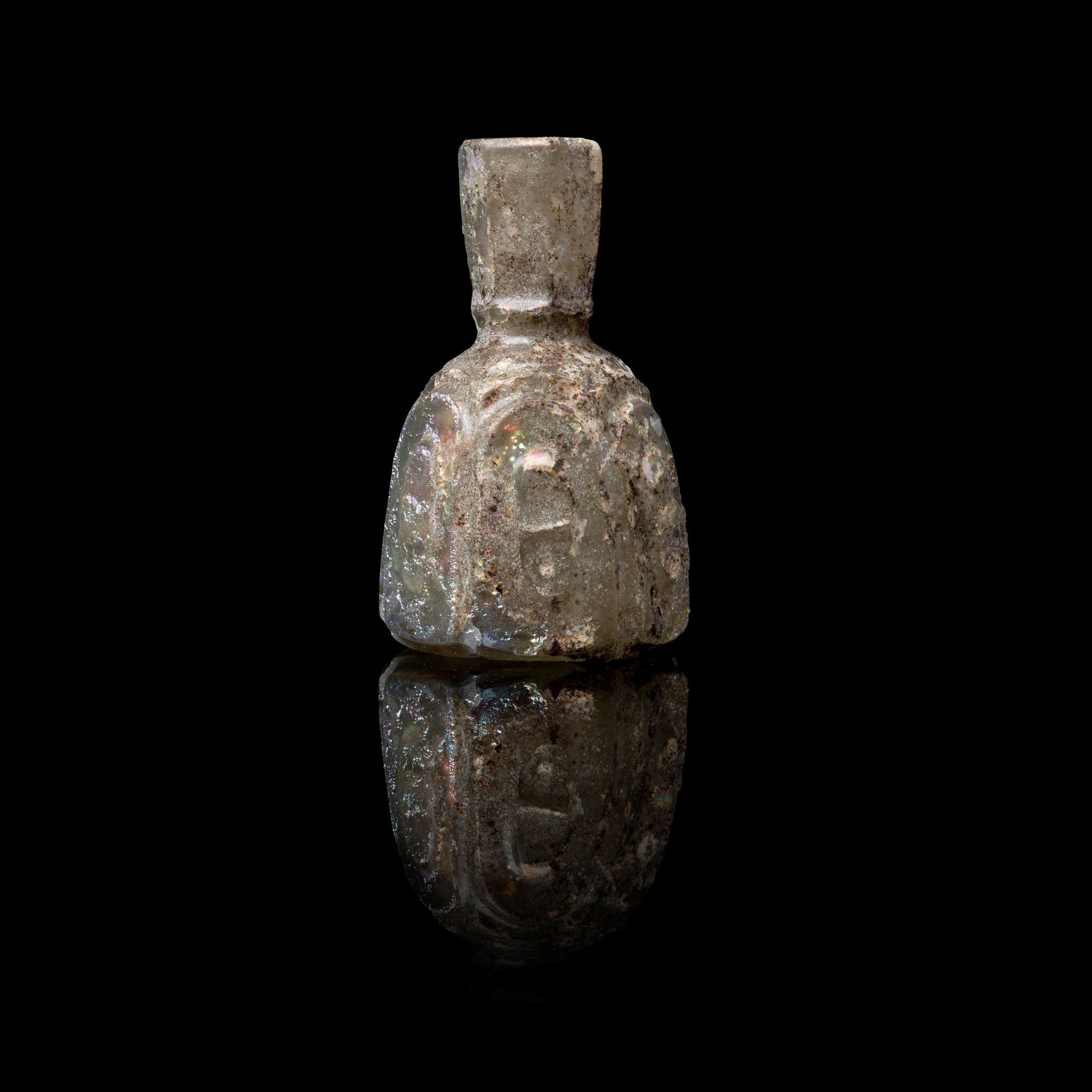 AN EARLY ISLAMIC MINIATURE GLASS PERFUME BOTTLE