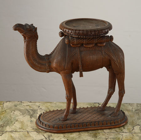A small Middle Eastern hardwood camel carved stand