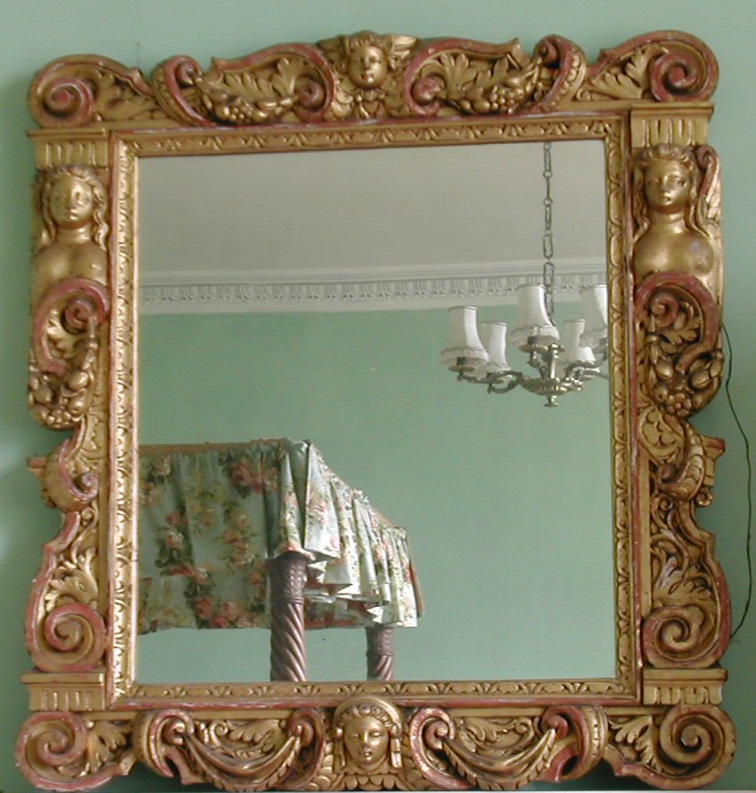 A gilt and carved wood wall mirror,