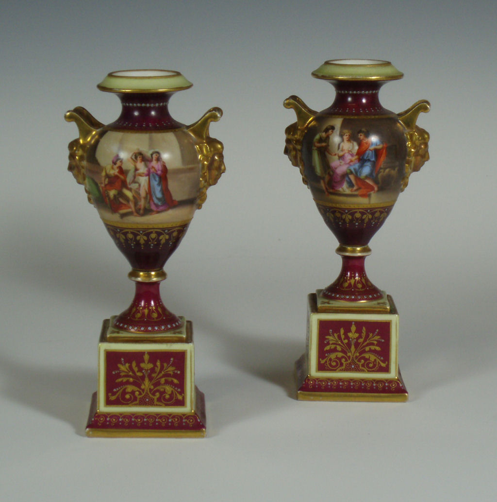 A pair of 19th century German porcelain twin handled urns