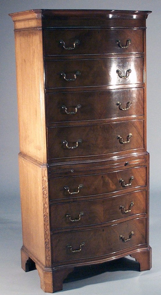 A reproduction serpentine chest on chest