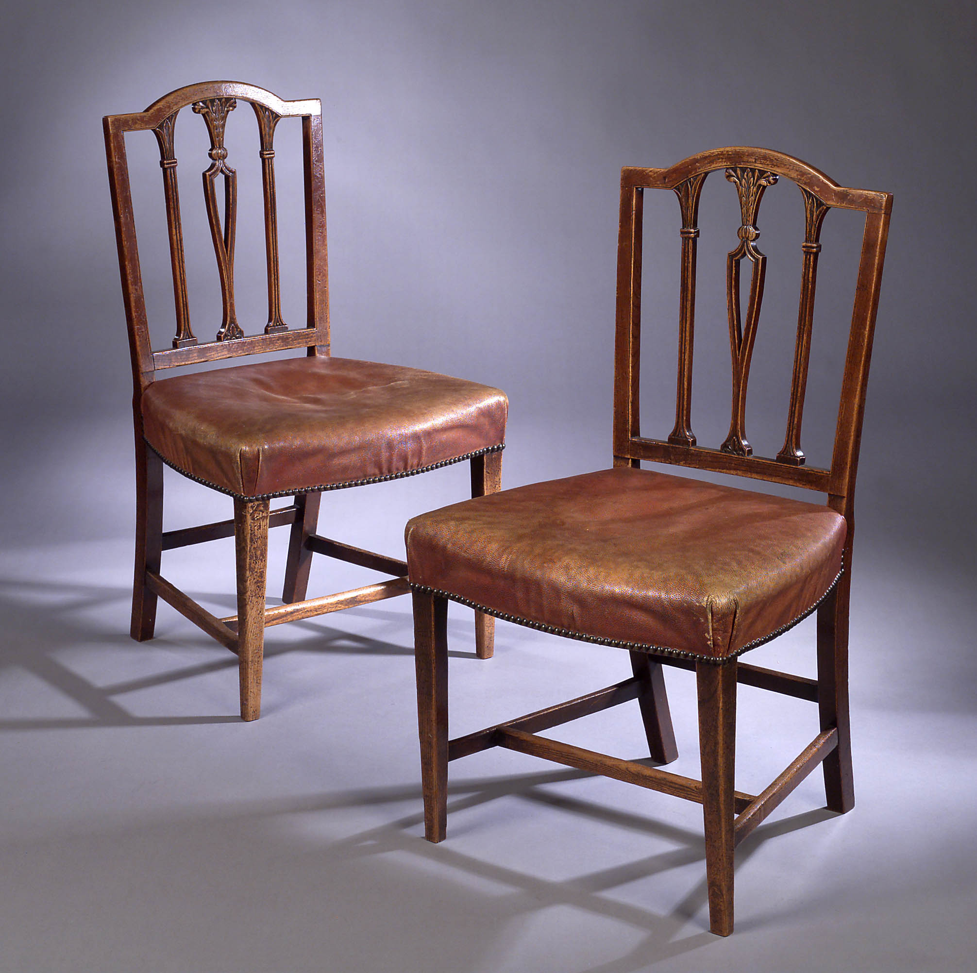 A pair of George III Hepplewhite elm dining chairs