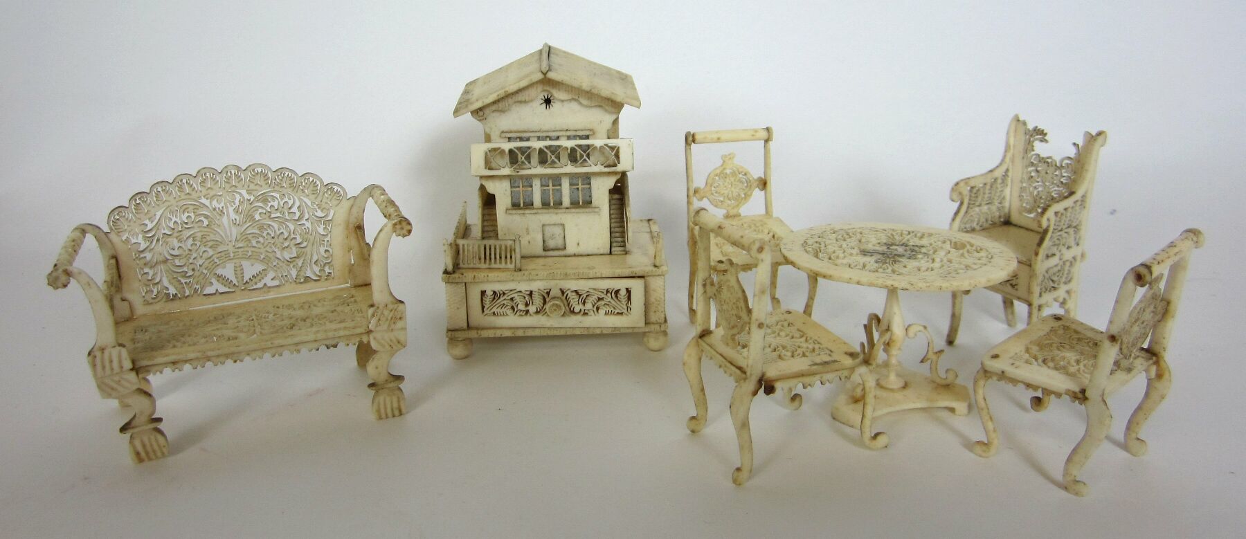 SMALL COLLECTION OF CARVED MINIATURE BONE FURNITURE
