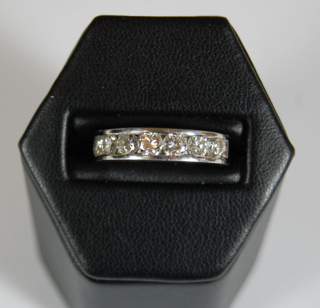 A platinum mounted diamond half-eternity ring