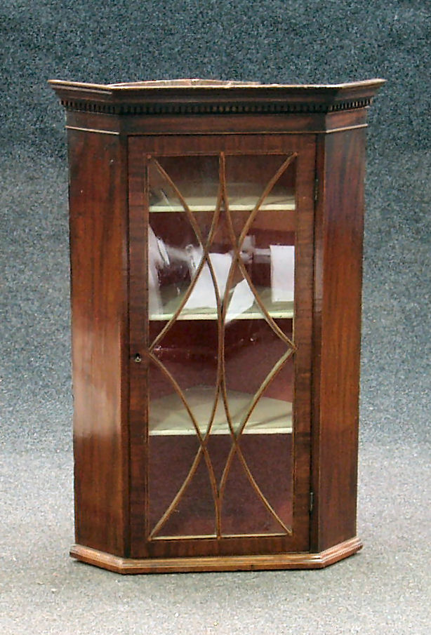 A George III mahogany corner cupboard