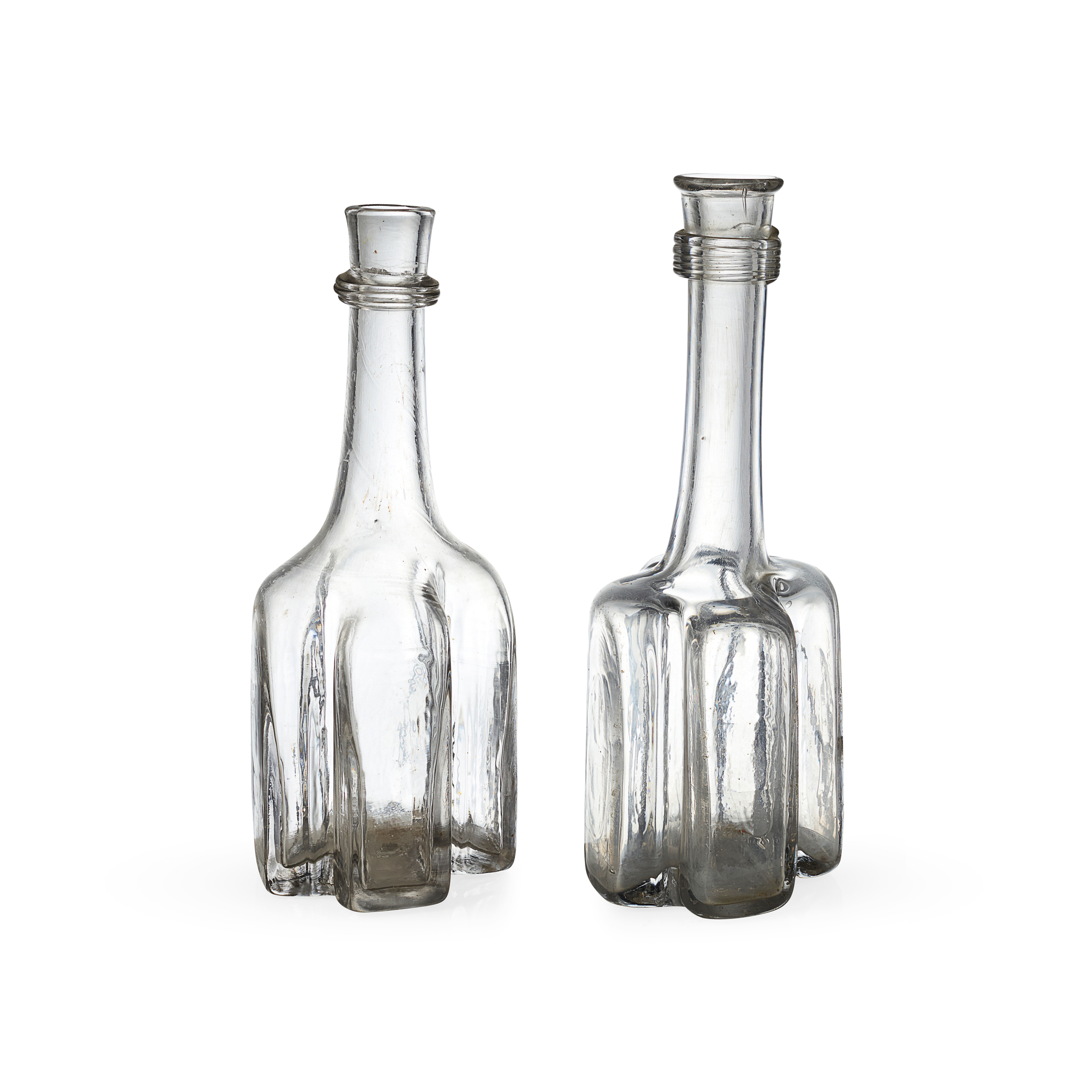 TWO CRUCIFORM GLASS DECANTERS OR SERVING BOTTLES