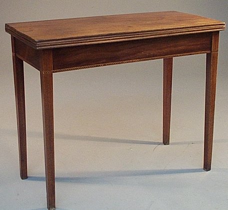 A Victorian mahogany foldover tea table