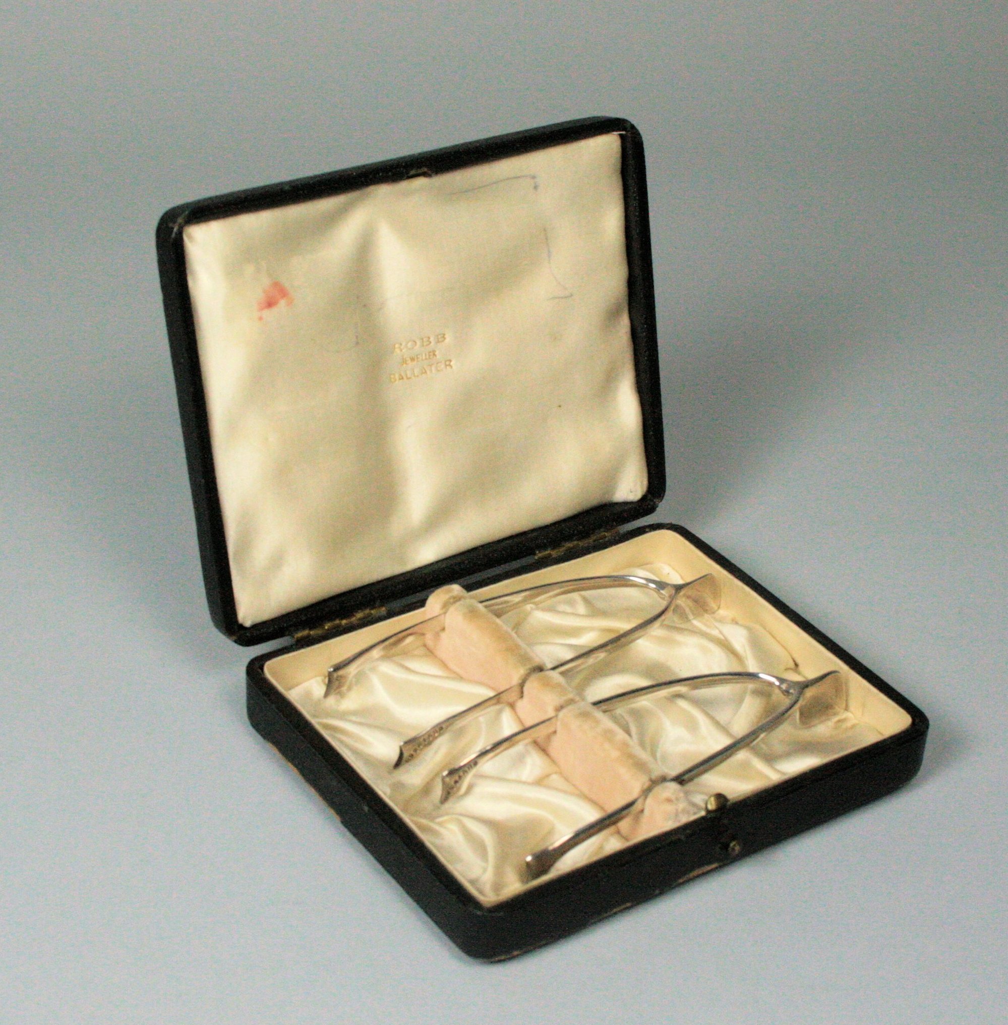 Ballater - two pairs of Scottish provincial silver Merrythought sugar tongs in original case