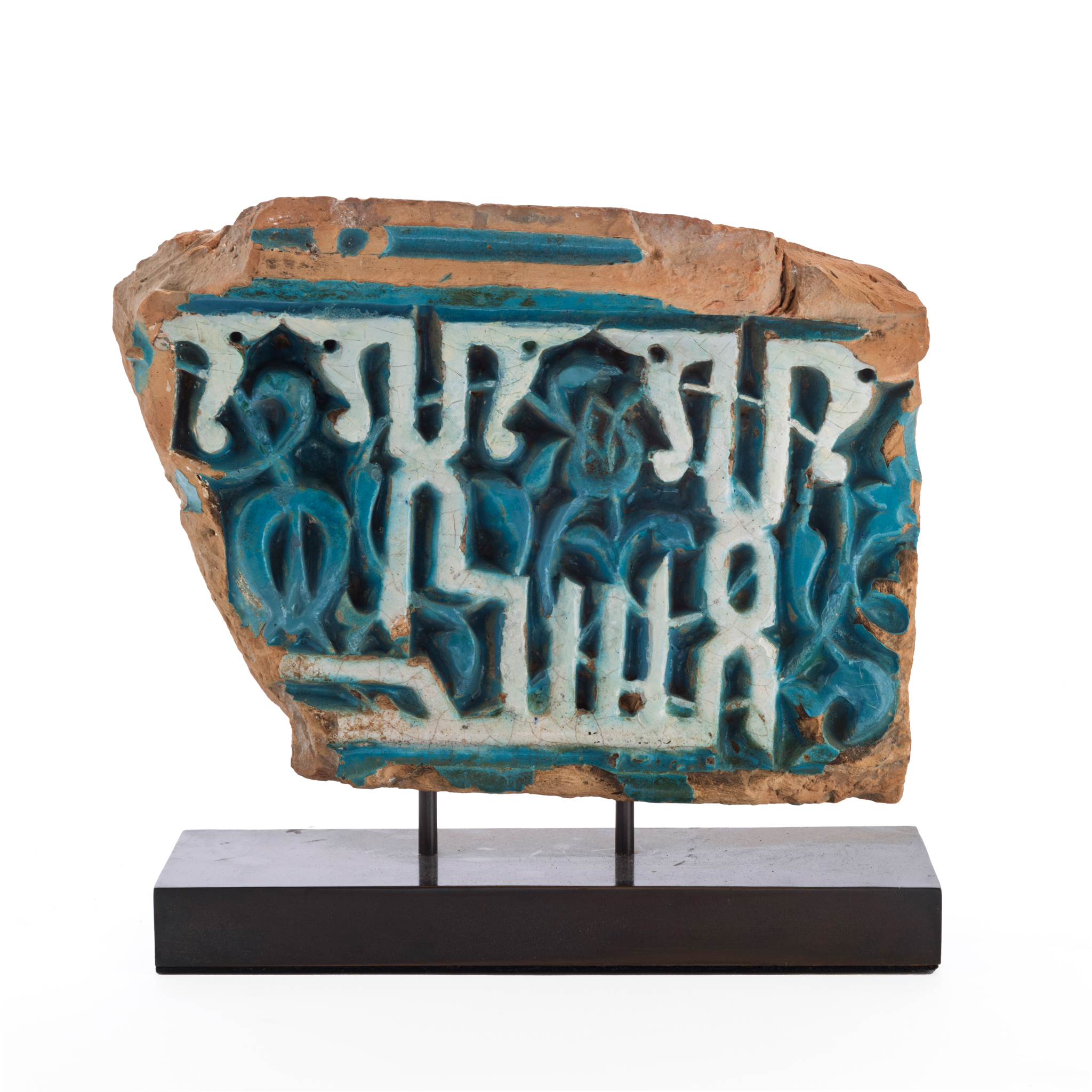 AN EARLY TIMURID CARVED POTTERY CALLIGRAPHIC BORDER TILE