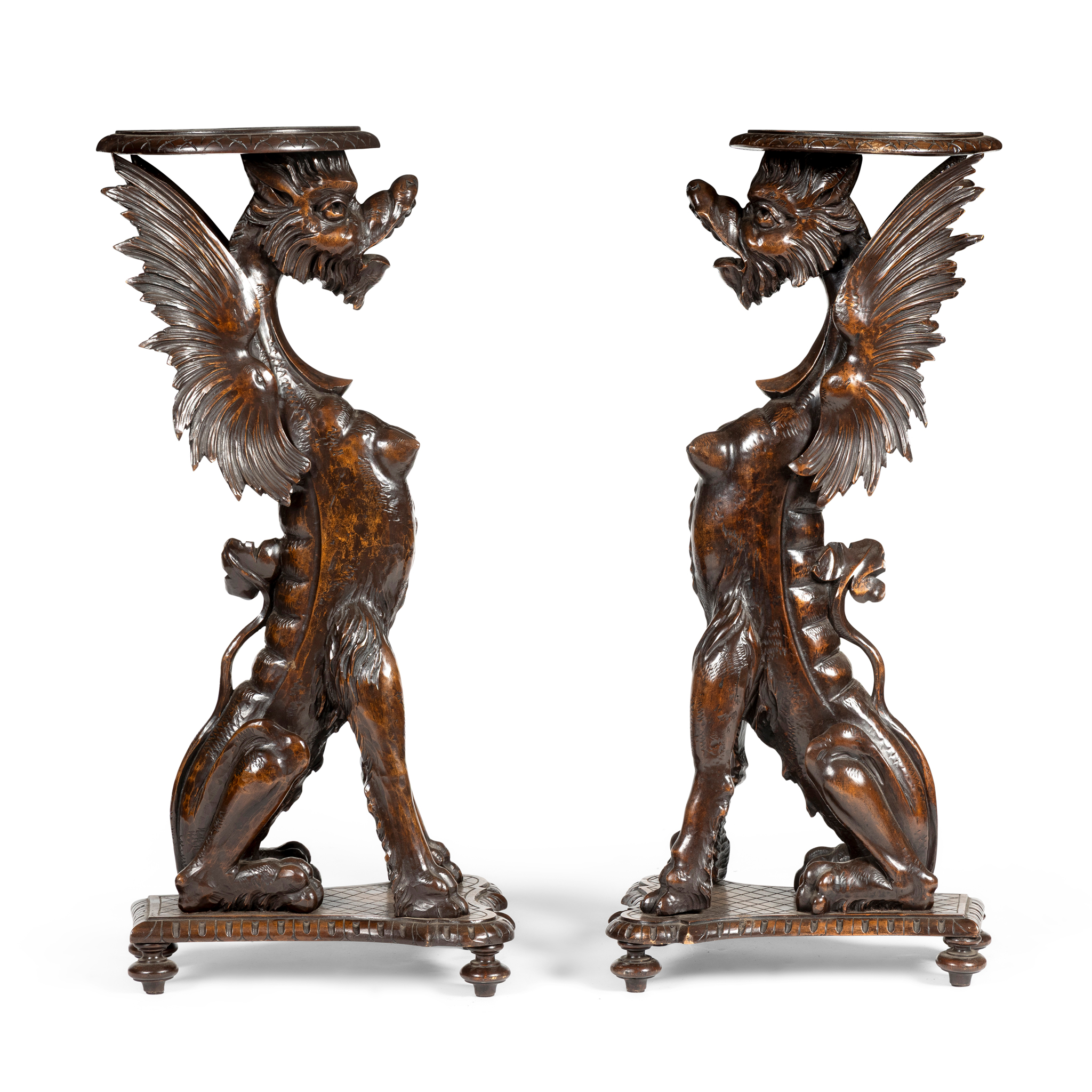A PAIR OF WALNUT GRIFFIN TORCHERE STANDS
