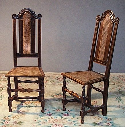A near pair of oak Carolean style high back chairs