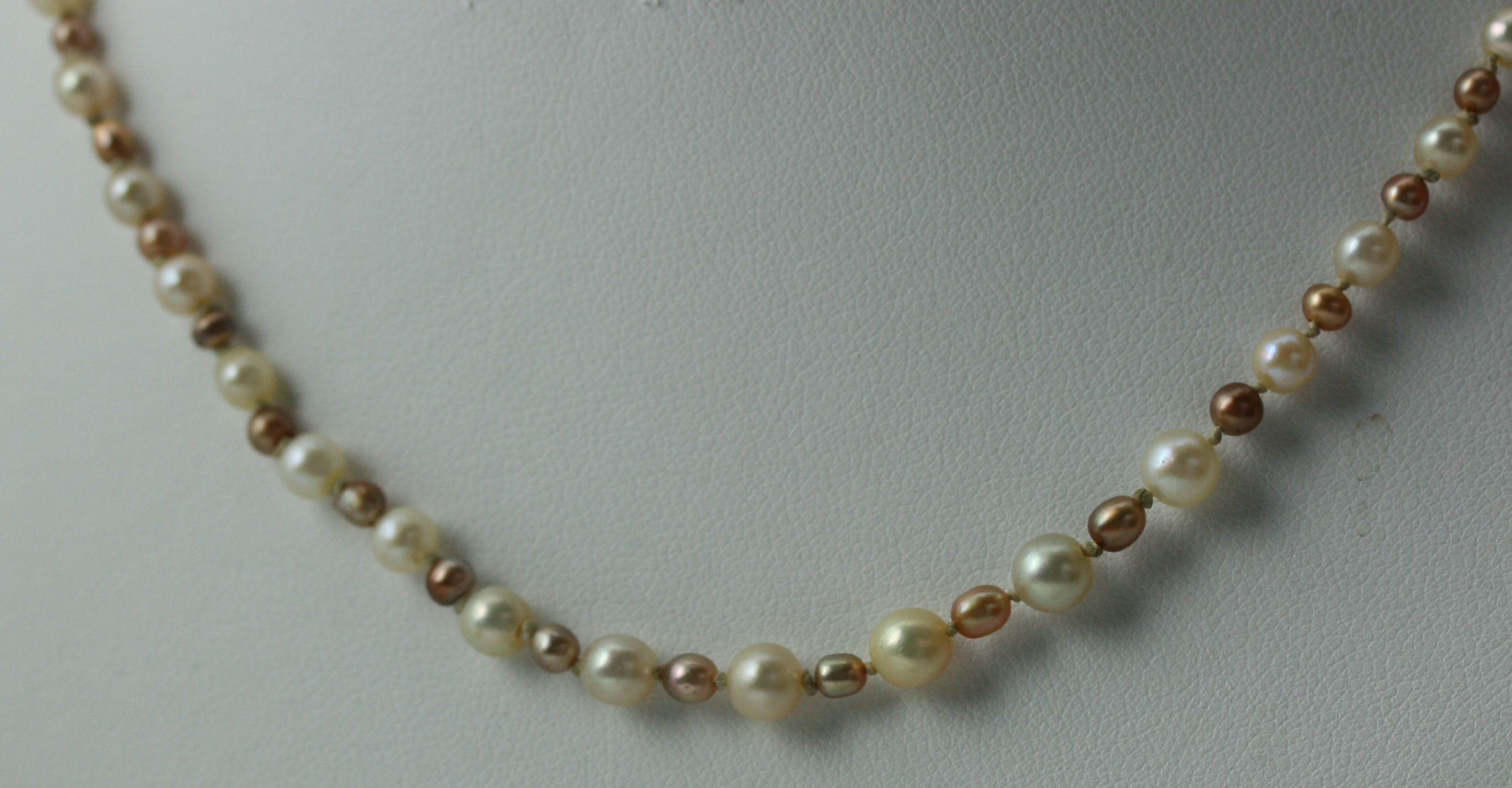 A graduated two-coloured CULTURED pearl necklace