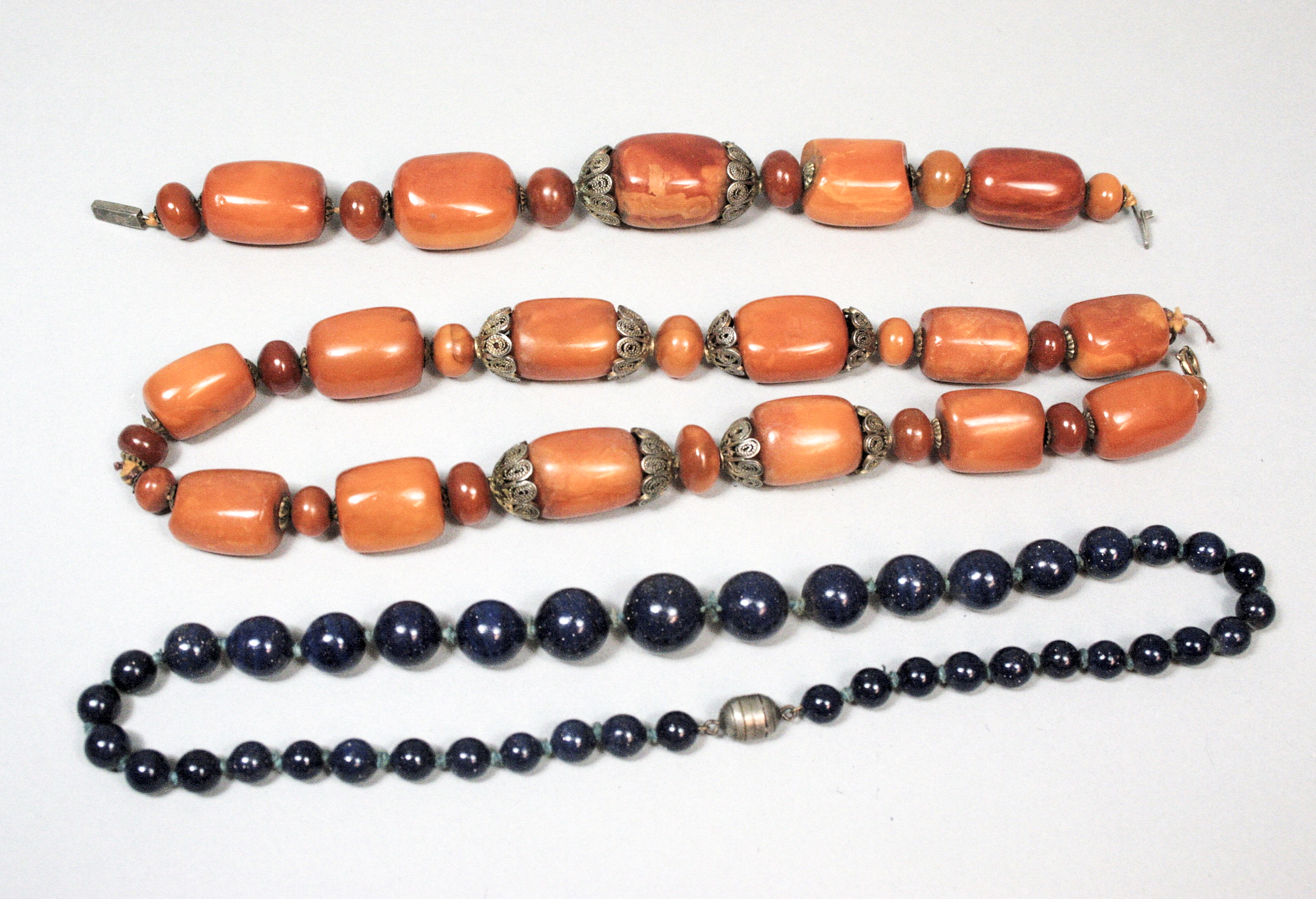 An amber and white metal necklace and bracelet