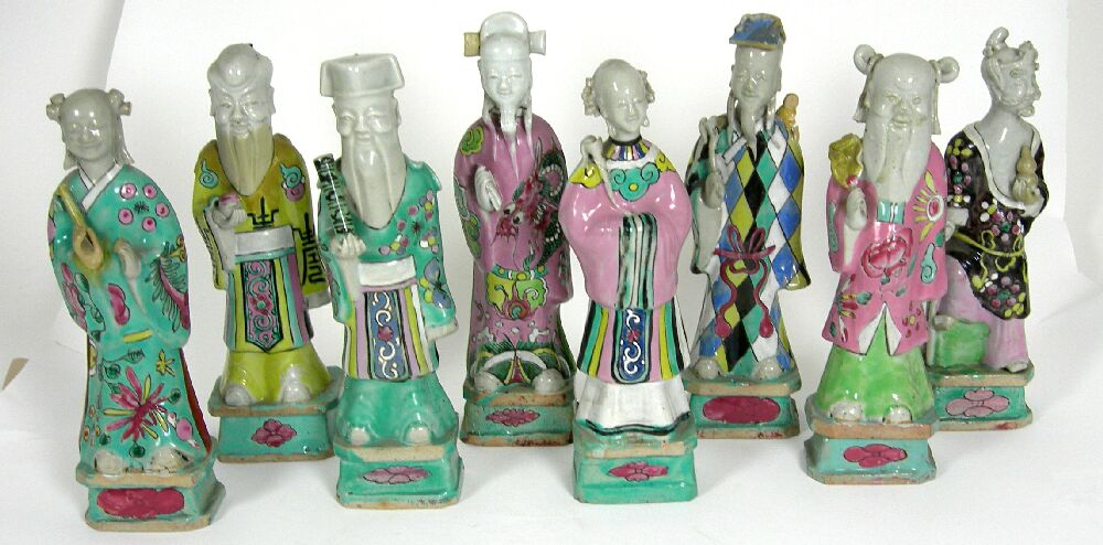 SEVEN CHINESE FAMILLE ROSE IMMORTALS AND A SHOU LAO