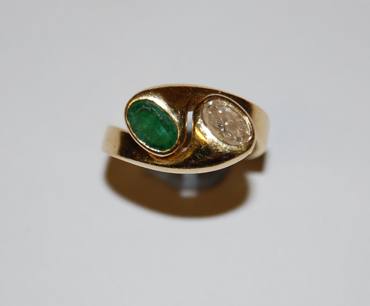An emerald and diamond set two-stone ring,
