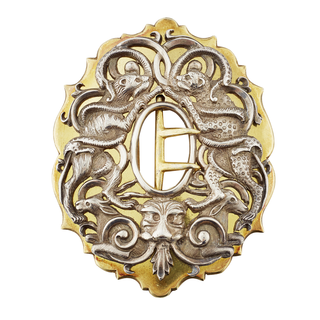 A CONTINENTAL SILVER AND GILT BUCKLE