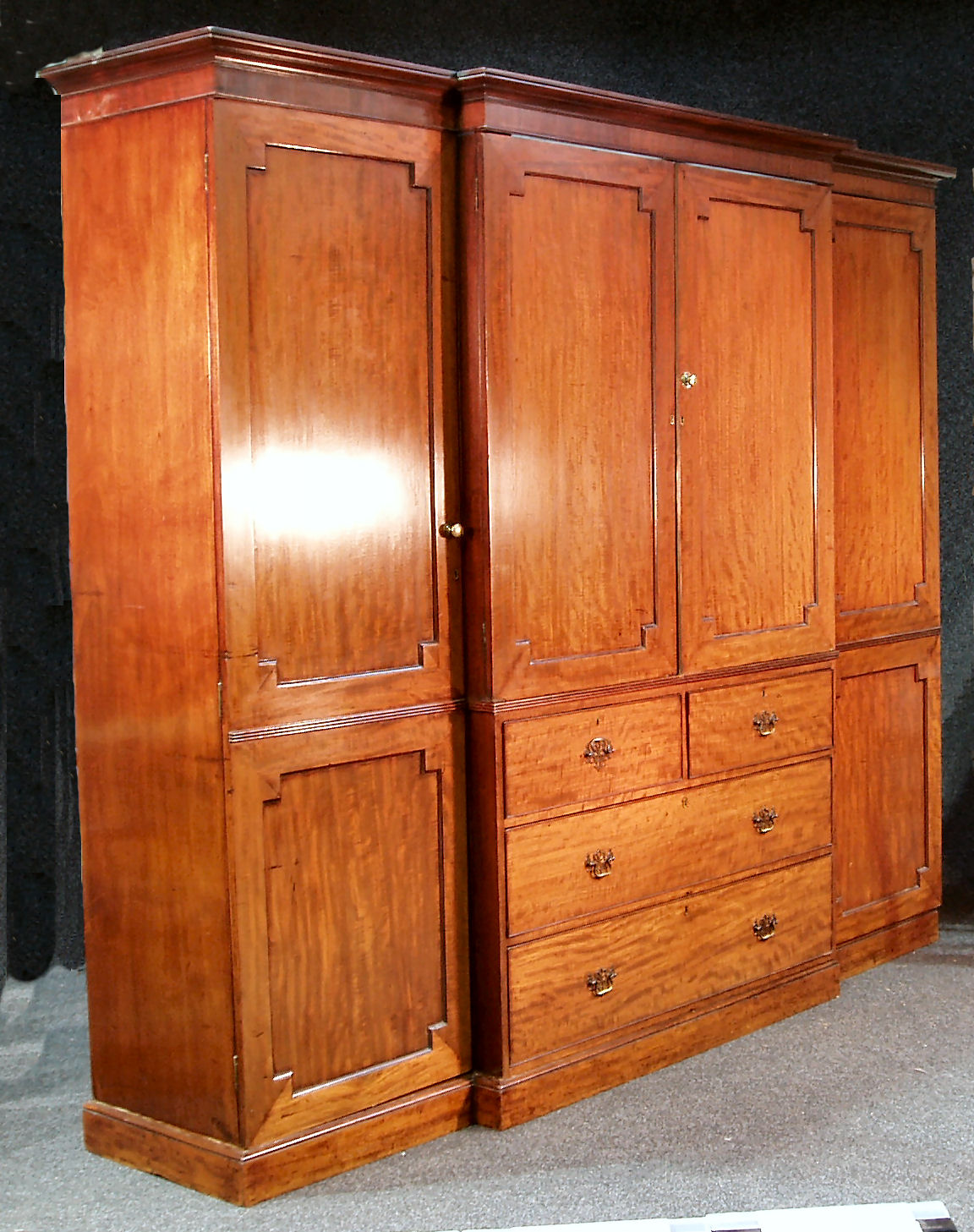 An early 19th century mahogany breakfront wardrobe