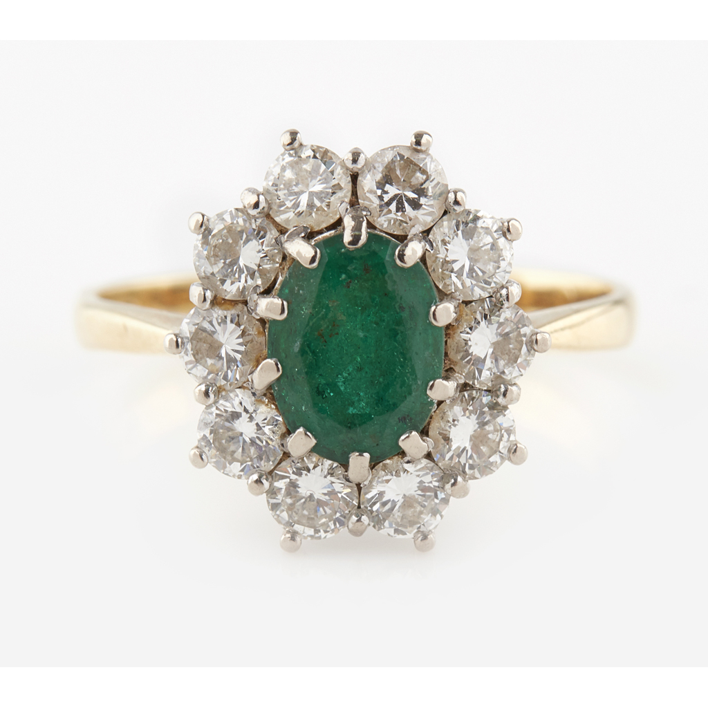 An emerald and diamond set cluster ring