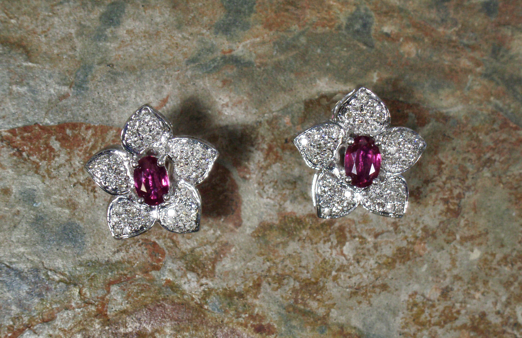 A pair of 18ct white gold mounted ruby and diamond set earrings,