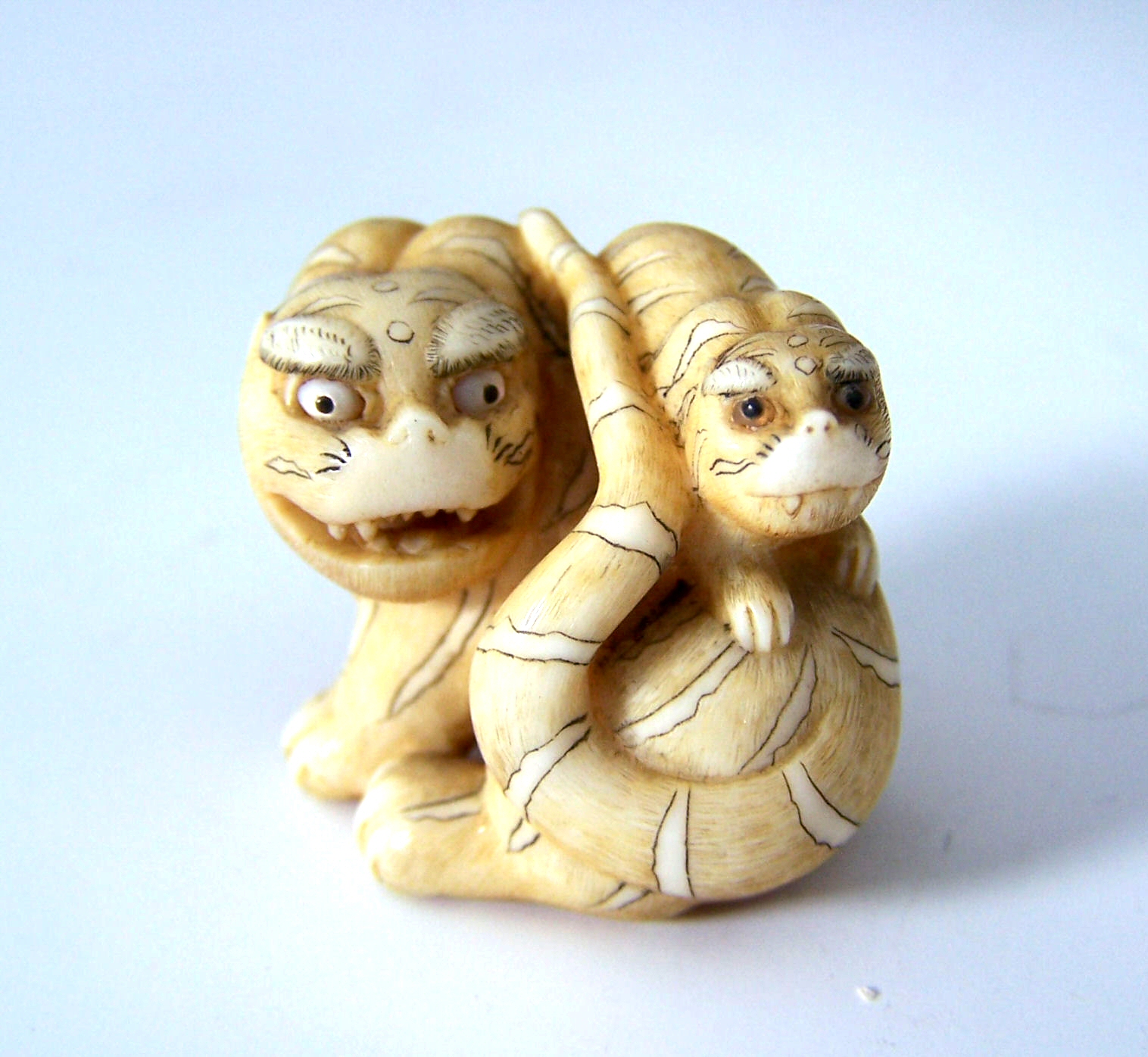 Ran'ichi, A small Japanese ivory figure of a tiger, mid 19th century,