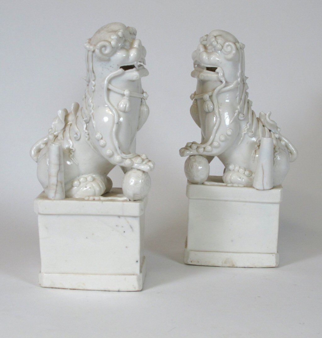 A pair of Chinese blanc de chine Buddhistic lions
