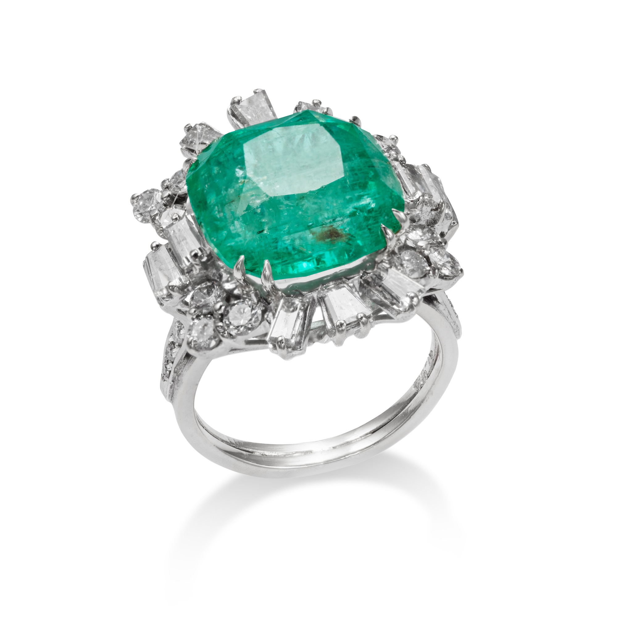 An emerald and diamond cluster ring