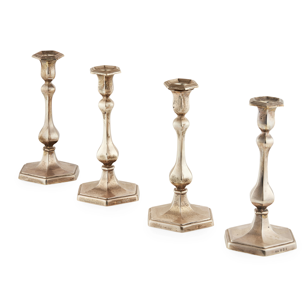 A set of four table candlesticks
