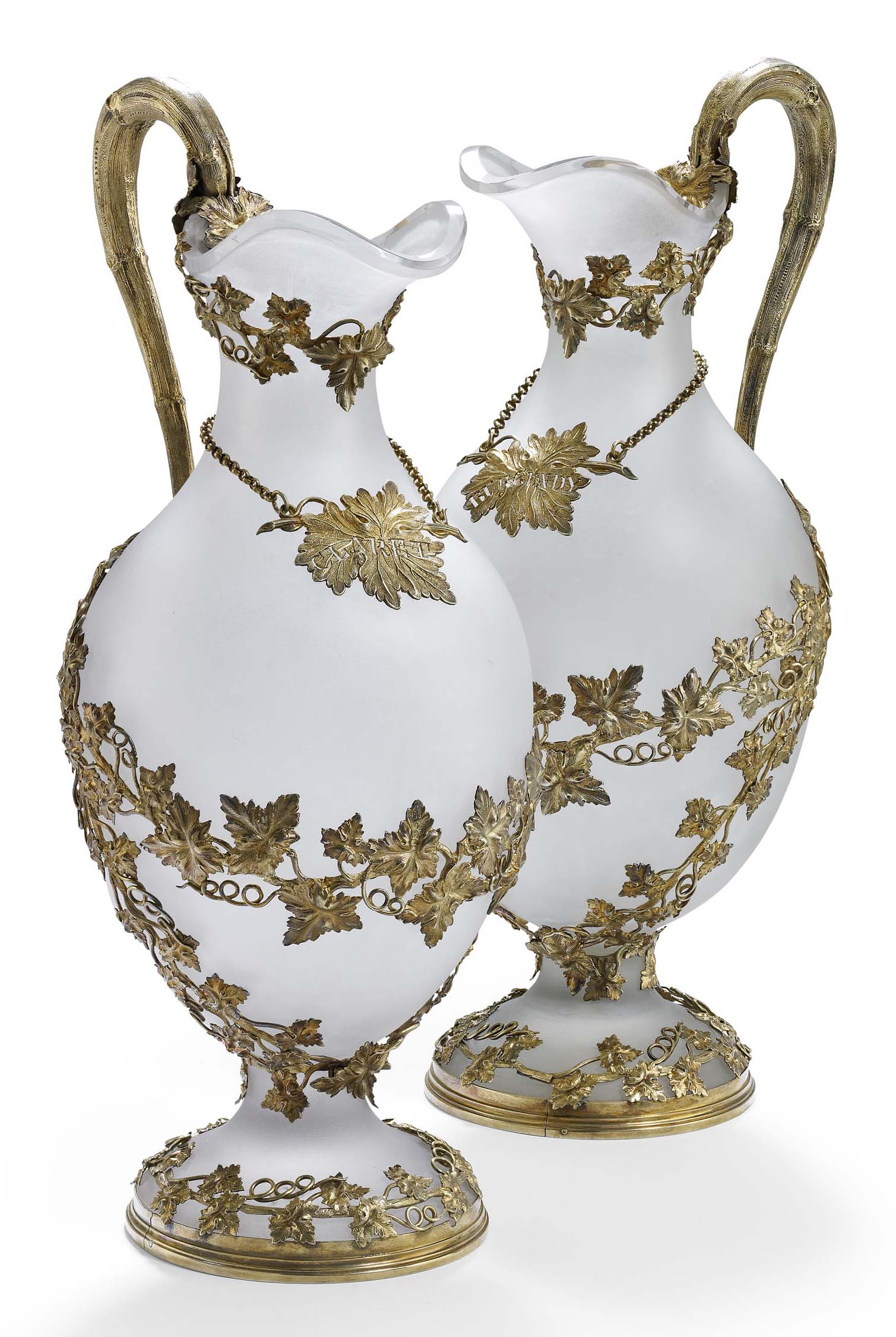 A pair of early Victorian silver-gilt frosted glass wine ewers
