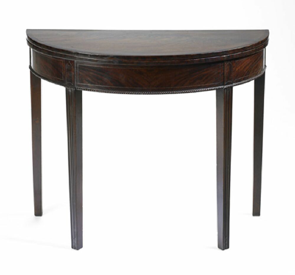 A George III mahogany, crossbanded and chequer strung demi-lune foldover games table